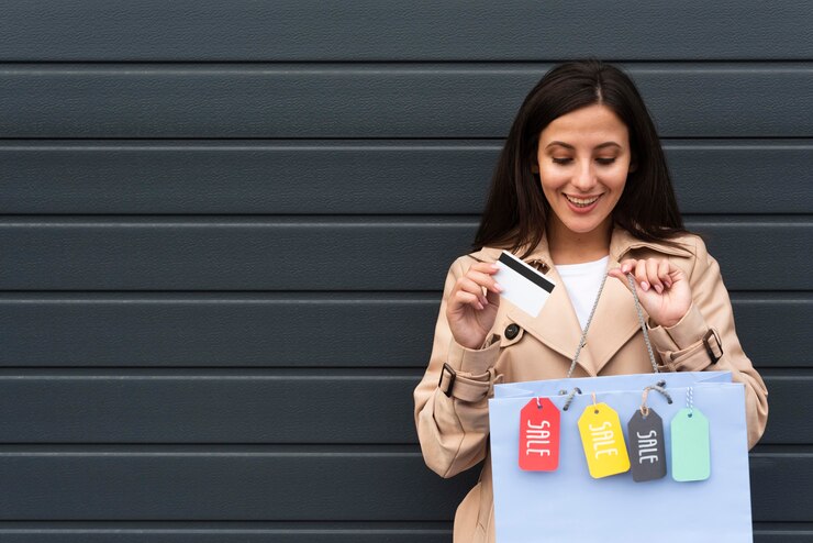 front-view-smiley-woman-holding-shopping-bags-with-tags-copy-space_23-2148684490